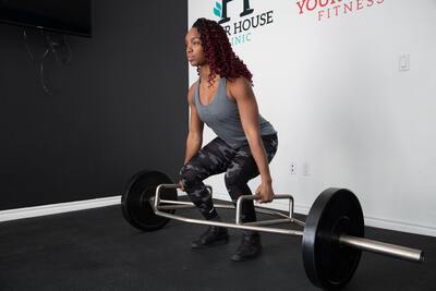 Woman performing deadlift exercise in west kelowna