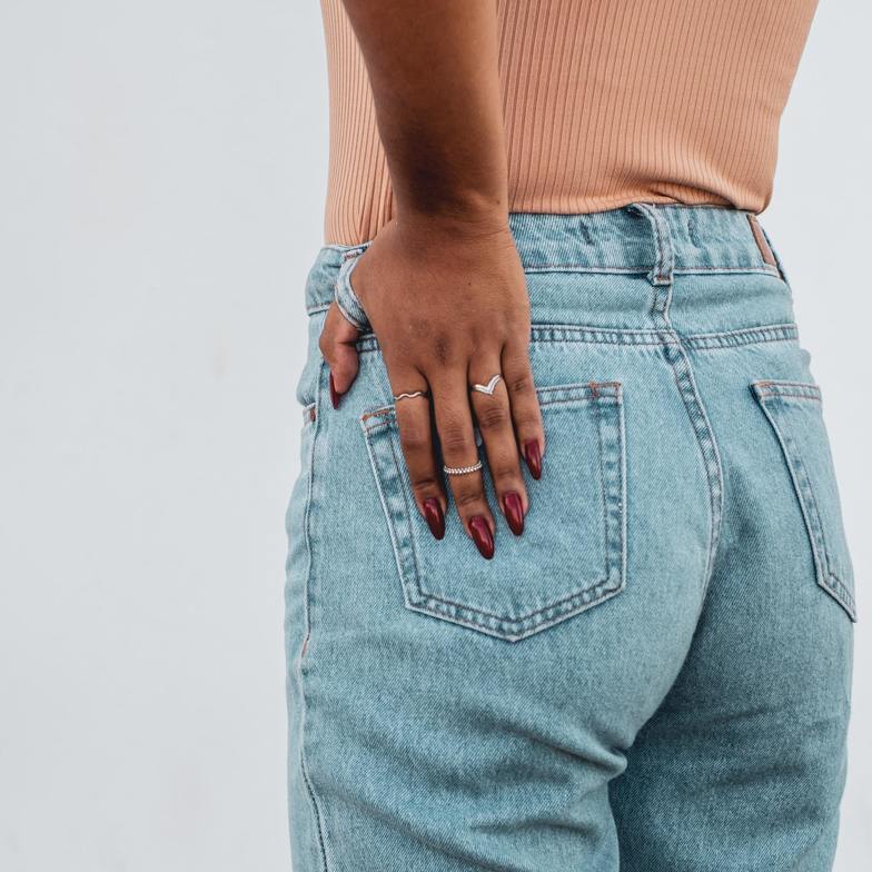 Women in blue jeans holding her sciatica pain