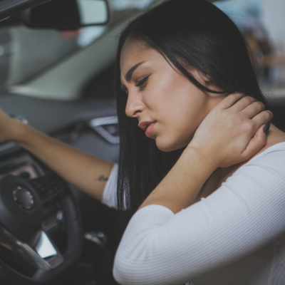 Woman holding neck after car accident in west kelowna