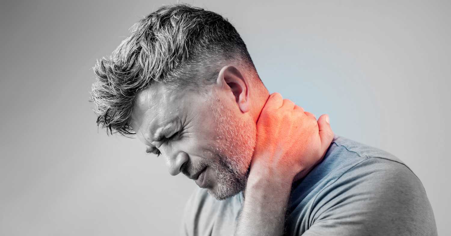 Man holding neck after a car accident due to whiplash pain