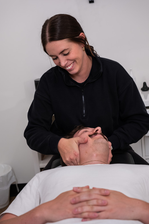 Chiropractor adjusting a neck